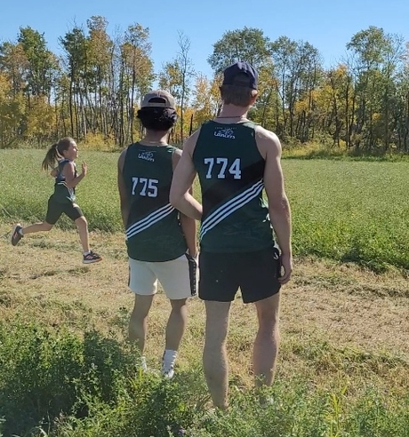 Two of Lake Lenore School's Grade 12 boys cheer on a Gr. 5 teammate in a district meet. "This is the leadership and example we hope our older students provide for our younger ones," Curtis Streuby says.